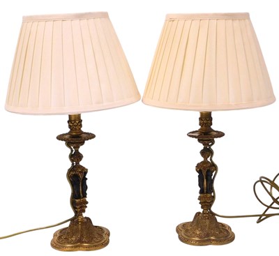 Lot 32 - A pair of 20thC continental brass candlestick...
