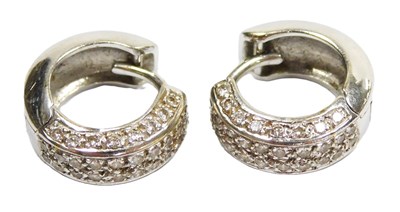 Lot 186 - A pair of diamond hoop earrings, pave set in...