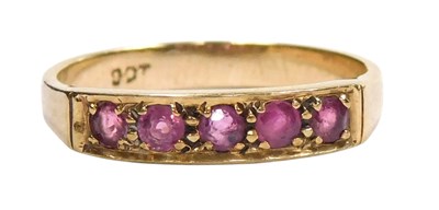 Lot 125 - A ruby five stone ring, channel set in yellow...