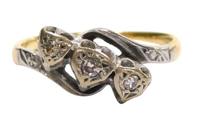 Lot 126 - A diamond three stone ring, in an illusion...