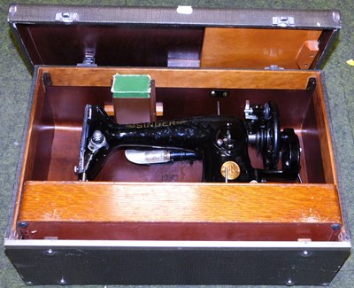 Lot 2123 - A cased Singer sewing machine, model number...