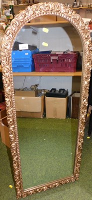 Lot 2150 - A gilt framed wall mirror of arched form,...