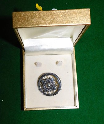 Lot 2188 - A white metal brooch, of circular pierced form...