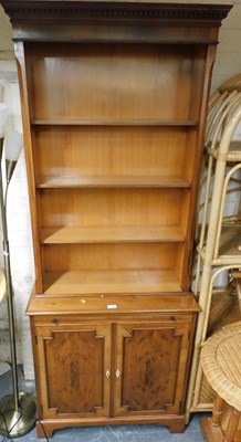 Lot 1053 - A yew wood display cabinet bookcase, the top...
