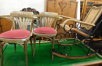 Lot 1081 - A metal framed rocking chair, with hardwood...