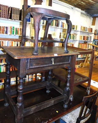 Lot 1103 - An early 20thC oak side table, with a frieze...