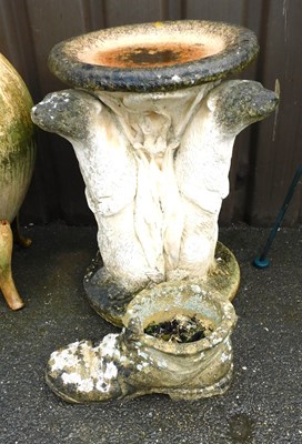 Lot 1128 - A composition stone garden birdbath, the...