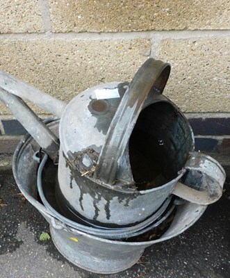 Lot 1156 - A galvanised metal watering can, together with...