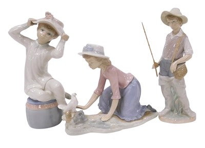 Lot 231 - A Lladro porcelain figure of a boy...