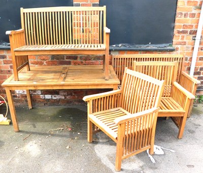 Lot 364 - A teak garden suite, comprising a table, with...