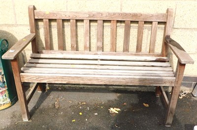 Lot 371 - A teak garden bench, with a slatted back and...