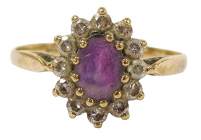 Lot 324 - A 9ct gold amethyst and cz ring, the oval cut...