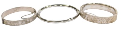 Lot 307 - Two silver bangles, with engraved decoration,...