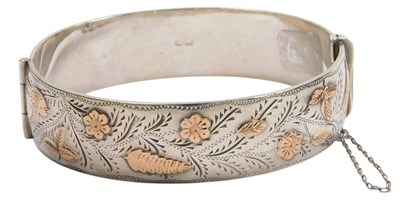 Lot 308 - A silver and gold plated bangle, with raised...