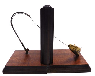 Lot 326 - A pair of teak and brass book ends, moulded...
