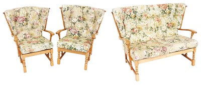 Lot 525 - An Ercol style light oak and beech wingback...