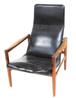 Lot 527 - A mid century teak armchair, with black...
