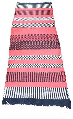 Lot 535 - A red ground rug, probably Scandinavian, with...