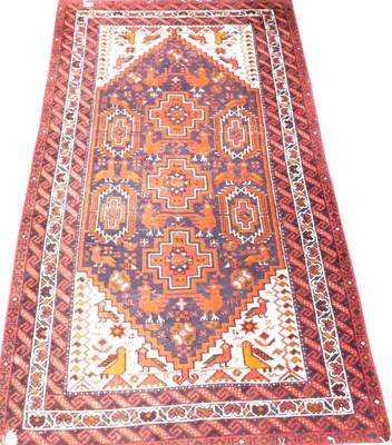 Lot 537 - A Caucasian black ground rug, the central...
