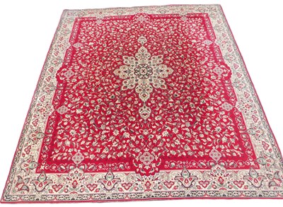 Lot 539 - A Kashan red ground rug, the field with a...