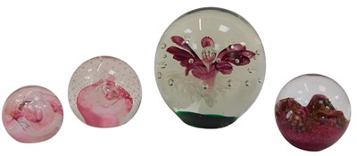 Lot 126 - Four glass paperweights, to include a large...