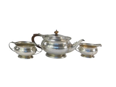Lot 317 - A George V silver three-piece tea set, with an...