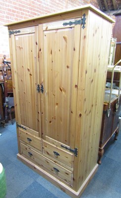 Lot 1001 - A pine wardrobe, of two doors over two drawers...