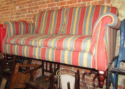 Lot 1018 - A two seater sofa, upholstered in striped...