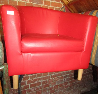 Lot 1021 - A red leatherette upholstered tub chair.