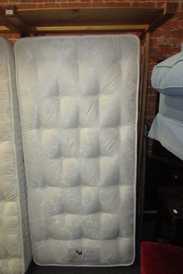 Lot 1025 - A lightwood frame single bed with mattress.