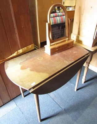 Lot 1047 - A teak drop leaf circular topped dining table,...