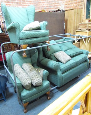 Lot 1049 - A three piece suite, including a two seater...