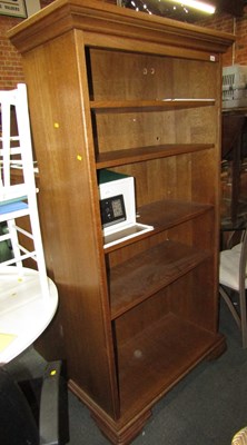 Lot 1056 - An oak open bookcase, with shelves, and safe...