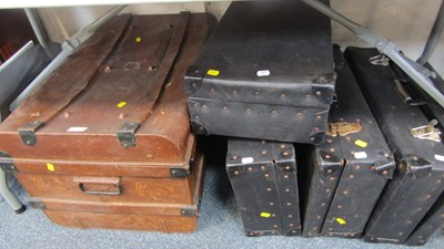 Lot 2018 - A tin trunk, metal bound, and four leatherette...
