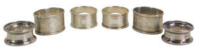 Lot 272 - Six silver napkin rings, of differing designs,...