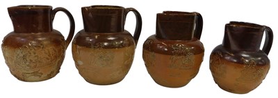 Lot 192 - Three Doulton Lambeth stoneware harvest jugs,...