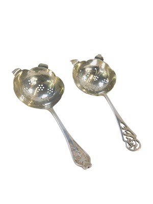 Lot 407 - Two Elizabeth II silver tea strainers, one...