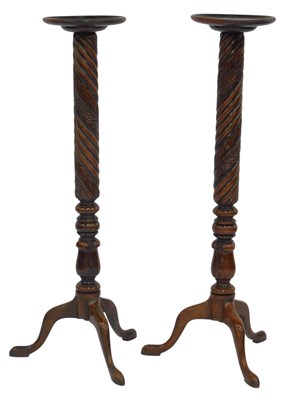 Lot 553 - A pair of mahogany torcheres, each with a...