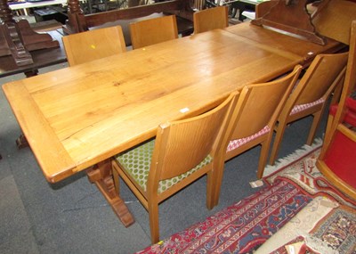 Lot 1125 - A light oak dining table, raised on single...