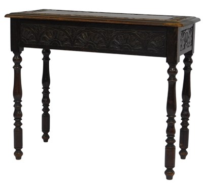 Lot 589 - A late 19thC carved oak side table, with a...