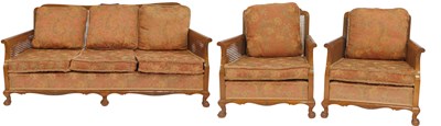 Lot 642 - A 20thC walnut framed bergere suite,...