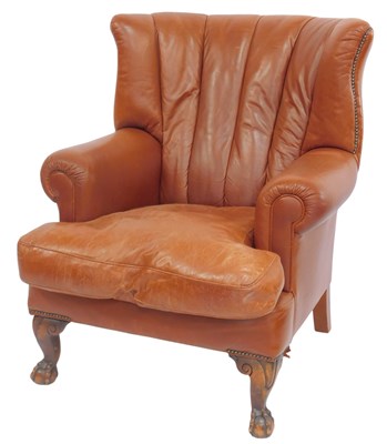 Lot 650 - A 20thC wingback armchair, upholstered in faux...