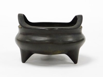 Lot 2 - A Chinese cast bronze tripod censer with loop...