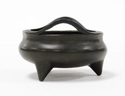 Lot 2 - A Chinese cast bronze tripod censer with loop...