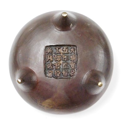 Lot 2 - A Chinese cast bronze tripod censer with loop...