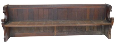 Lot 648 - A 19thC oak church pew, with a panelled back,...