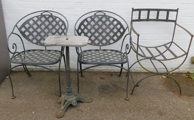 Lot 658 - A pair of cast and wrought metal garden chairs,...