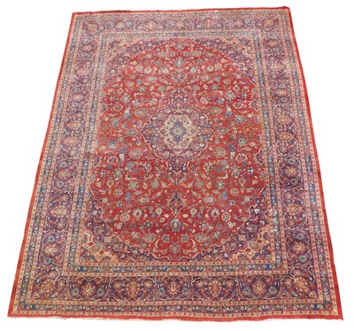 Lot 688 - A Persian Kashan carpet, on a red ground, with...