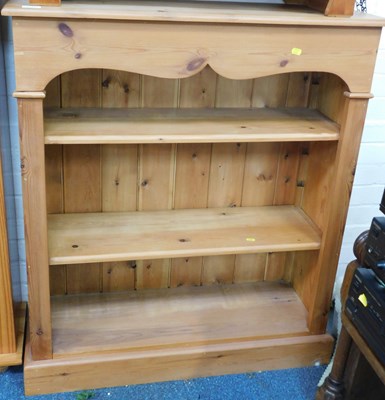 Lot 1186 - A pine bookcase of three shelves, raised on a...