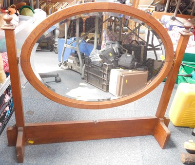 Lot 2179 - A wooden framed oval bevelled mirror, on a...